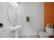 Small half bathroom with pedestal sink and orange accent wall at 20149 Lagente Cir, Venice, FL 34293