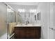 Double vanity bathroom with dark brown cabinets and a shower at 20149 Lagente Cir, Venice, FL 34293
