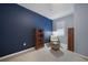 Bedroom with bookcase, window seat, and blue accent wall at 20149 Lagente Cir, Venice, FL 34293