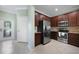 Kitchen with stainless steel appliances and dark wood cabinets at 20149 Lagente Cir, Venice, FL 34293