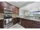 Modern kitchen with stainless steel appliances and wood cabinets at 20149 Lagente Cir, Venice, FL 34293