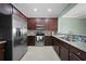Modern kitchen with stainless steel appliances and wood cabinets at 20149 Lagente Cir, Venice, FL 34293
