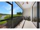 Screened lanai overlooking a pond with seating for two at 20149 Lagente Cir, Venice, FL 34293
