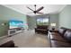 Living Room with leather furniture and sliding glass doors to lanai at 20149 Lagente Cir, Venice, FL 34293