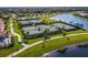 Six lighted tennis courts with walking paths nearby and lake view at 20149 Lagente Cir, Venice, FL 34293