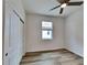 Simple bedroom with ceiling fan and wood-look flooring at 25245 Delgado Dr, Punta Gorda, FL 33955