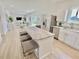 Modern kitchen boasts stainless steel appliances, white cabinets and a large kitchen island at 3140 Sweet Gum Dr, Punta Gorda, FL 33982