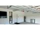 Spacious garage with large TV, storage, and HVAC unit at 3140 Sweet Gum Dr, Punta Gorda, FL 33982
