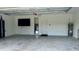 Bright and clean garage offers ample storage space and a mounted TV at 3140 Sweet Gum Dr, Punta Gorda, FL 33982