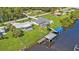 Aerial view showcasing canal-front home, private pool, and dock at 3494 Yukon Dr, Port Charlotte, FL 33948