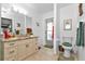 Bathroom with granite countertops, toilet, and access to exterior at 3494 Yukon Dr, Port Charlotte, FL 33948