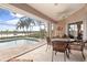 Enclosed pool and patio area with water view at 4077 La Costa Island Ct, Punta Gorda, FL 33950