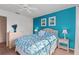 Guest bedroom with teal walls and white wicker furniture at 4077 La Costa Island Ct, Punta Gorda, FL 33950