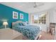 Bedroom with teal accent wall, king bed, and window seat at 4077 La Costa Island Ct, Punta Gorda, FL 33950
