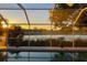 Sunrise view from screened pool area overlooking a tranquil lake at 4077 La Costa Island Ct, Punta Gorda, FL 33950