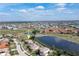 Aerial view of a house near a golf course and lake at 4077 La Costa Island Ct, Punta Gorda, FL 33950