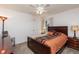 Bedroom with dark wood furniture and orange bedding at 4077 La Costa Island Ct, Punta Gorda, FL 33950
