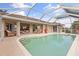 Inviting kidney-shaped pool with screened enclosure and patio access at 4077 La Costa Island Ct, Punta Gorda, FL 33950