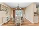 Bright dining room with hardwood floors, a glass-top table, and access to the patio at 1111 La Salina Ct, Punta Gorda, FL 33950