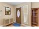 Bright and airy entryway with wood floors, a built-in shelving unit, and a decorative mirror at 1111 La Salina Ct, Punta Gorda, FL 33950