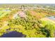 Aerial view showcasing a home's location near a golf course and lake at 5291 Laurel Oak Ct, North Port, FL 34287