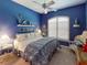Primary bedroom with king-size bed and blue decor at 5291 Laurel Oak Ct, North Port, FL 34287