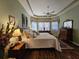 Main bedroom with soft green walls and hardwood floors at 5291 Laurel Oak Ct, North Port, FL 34287