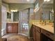 Main bathroom with double sinks, walk-in shower and tile flooring at 5291 Laurel Oak Ct, North Port, FL 34287
