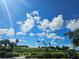 Landscaped golf course with palm trees under a blue sky at 5291 Laurel Oak Ct, North Port, FL 34287