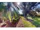Landscaped backyard with lush greenery and mature trees at 5291 Laurel Oak Ct, North Port, FL 34287