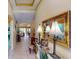 Elegant entryway featuring a glass-top console table and ornate mirror at 5291 Laurel Oak Ct, North Port, FL 34287
