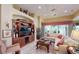 Bright living room featuring built-in shelving and hardwood floors at 5291 Laurel Oak Ct, North Port, FL 34287