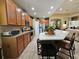 Modern kitchen features wood cabinets, stainless steel appliances, and a large island at 5291 Laurel Oak Ct, North Port, FL 34287