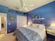 Primary bedroom with king-size bed and blue decor at 5291 Laurel Oak Ct, North Port, FL 34287