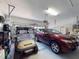 Two-car garage with golf cart and additional storage space at 5291 Laurel Oak Ct, North Port, FL 34287