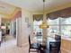 Charming breakfast nook with a glass-top table and stained-glass lighting at 5291 Laurel Oak Ct, North Port, FL 34287