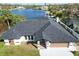 Single-Gathering home with a dark gray roof and a two-car garage at 509 Clearview Dr, Port Charlotte, FL 33953
