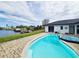 Inviting kidney-shaped pool with spa, overlooking the canal at 509 Clearview Dr, Port Charlotte, FL 33953
