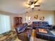 Relaxing living room with reclining sofas, a coffee table, and a ceiling fan at 509 Clearview Dr, Port Charlotte, FL 33953