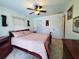 Bedroom with a queen-size bed, ceiling fan, and ample closet space at 509 Clearview Dr, Port Charlotte, FL 33953