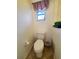 Small bathroom with toilet and window for natural light at 509 Clearview Dr, Port Charlotte, FL 33953