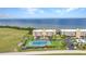 Scenic aerial view of a waterfront condo community, featuring a tennis court and lush landscaping at 101 N Marion Ct # 122, Punta Gorda, FL 33950
