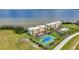 Aerial view showcasing condos, tennis courts, a pool, and scenic waterfront views at 101 N Marion Ct # 122, Punta Gorda, FL 33950