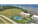 Scenic aerial view of waterfront condo community, featuring a tennis court and lush landscaping at 101 N Marion Ct # 122, Punta Gorda, FL 33950