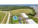 Aerial view of a condominium complex featuring a tennis court, parking, and access to a waterfront area at 101 N Marion Ct # 122, Punta Gorda, FL 33950