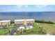 Stunning aerial view of a beachfront condominium complex with a swimming pool and manicured lawns at 101 N Marion Ct # 122, Punta Gorda, FL 33950