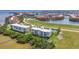 Scenic aerial view of condos near the water, featuring a tennis court and lovely landscaping at 101 N Marion Ct # 122, Punta Gorda, FL 33950