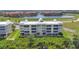 Stylish waterfront condo building with elevated parking and scenic lake views, perfect for modern living at 101 N Marion Ct # 122, Punta Gorda, FL 33950