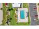 Overhead shot of a pool surrounded by a concrete deck with tables and chairs, with some car parking nearby at 101 N Marion Ct # 122, Punta Gorda, FL 33950