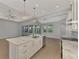 Modern kitchen with white cabinets and marble island at 1411 Liggett Cir, Port Charlotte, FL 33953